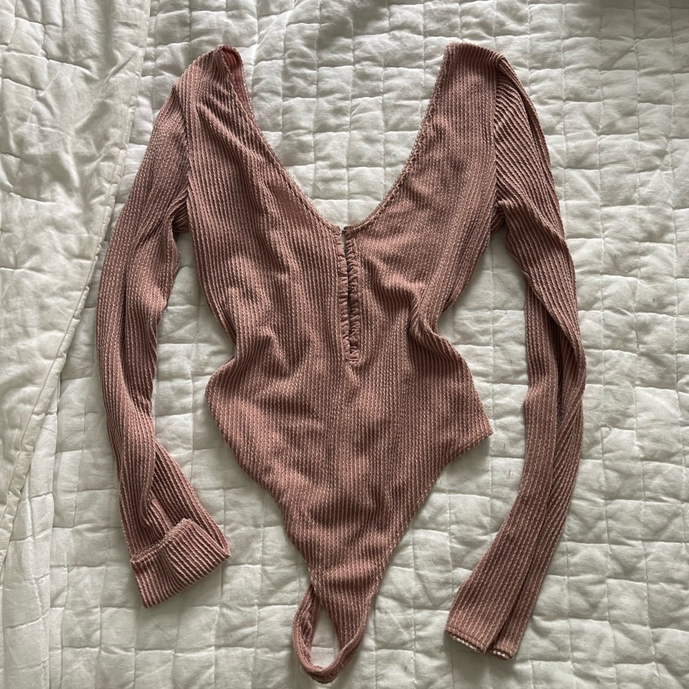 Out from under pink body suit